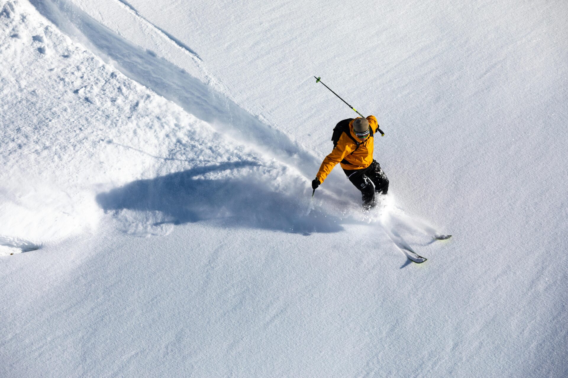 Man skiing in a yellow jacket