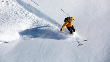 Man skiing in a yellow jacket