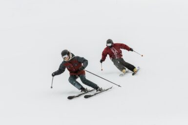 two skiers skiing