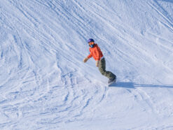 orange jacket snowboarder