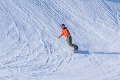 orange jacket snowboarder