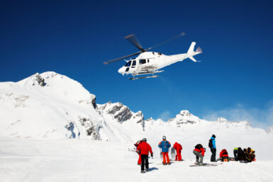 skiiers and helicopter