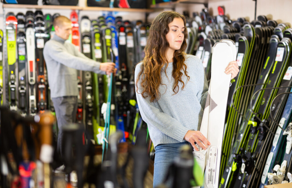 woman selecting skis