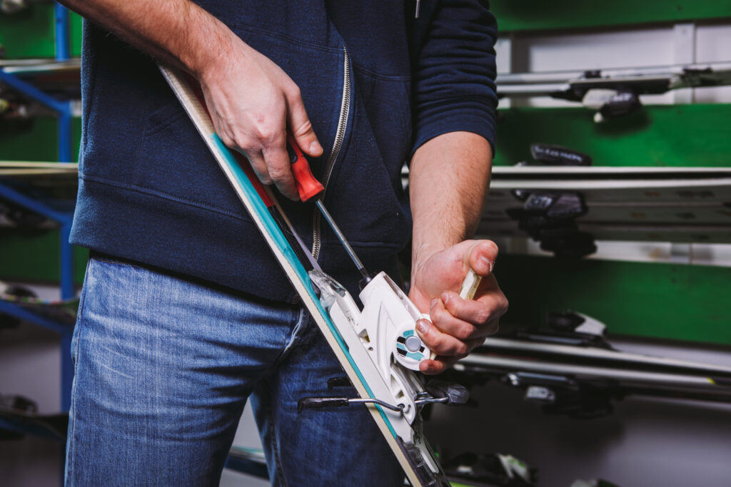 ski bindings being adjusted