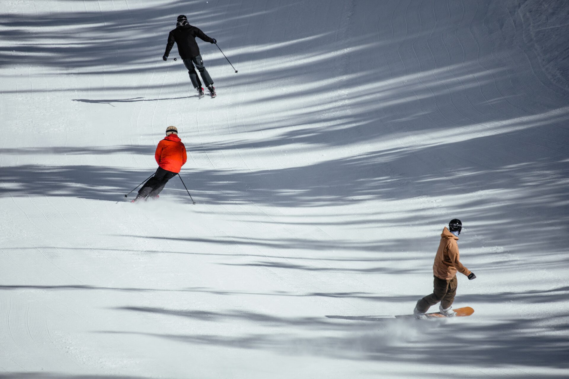 Skiers and a snowboarder